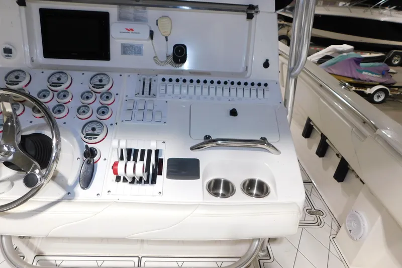 Slide: The Image of Center console of a 2005 Fountain 34 boat with gauges and controls. - 25