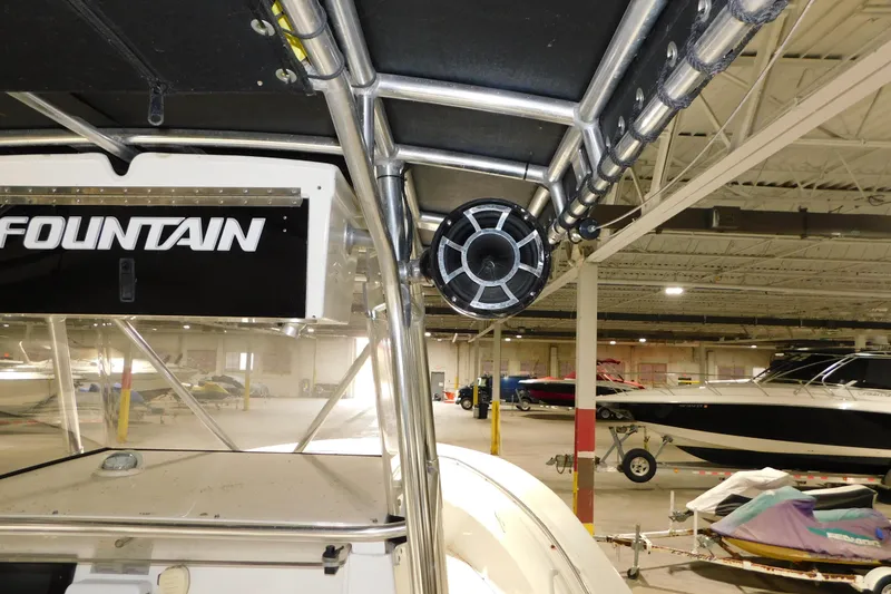 Slide: The Image of 2005 Fountain 34 Center Console boat in indoor storage, featuring speaker and sturdy framework. - 27