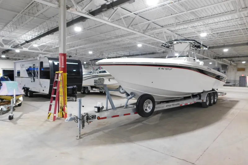Slide: The Image of 2005 Fountain 34 Center Console boat on trailer in indoor storage facility. - 3