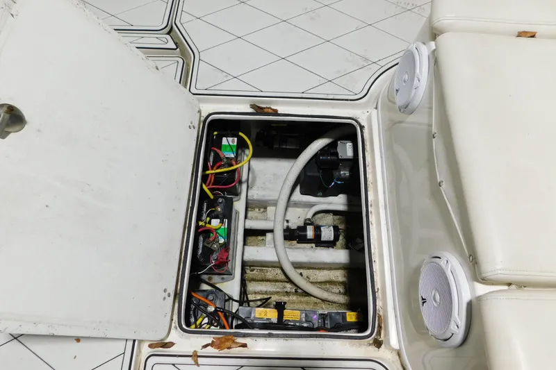 Slide: The Image of Open hatch of 2005 Fountain 34 Center Console showing electrical components and wiring. - 30