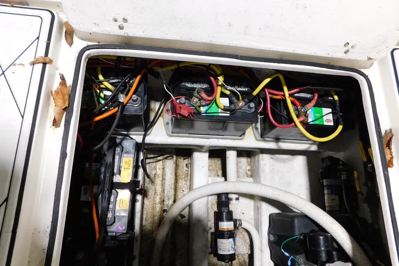 Slide: The Image of Electrical compartment of a 2005 Fountain 34 Center Console boat with batteries and wiring. - 31
