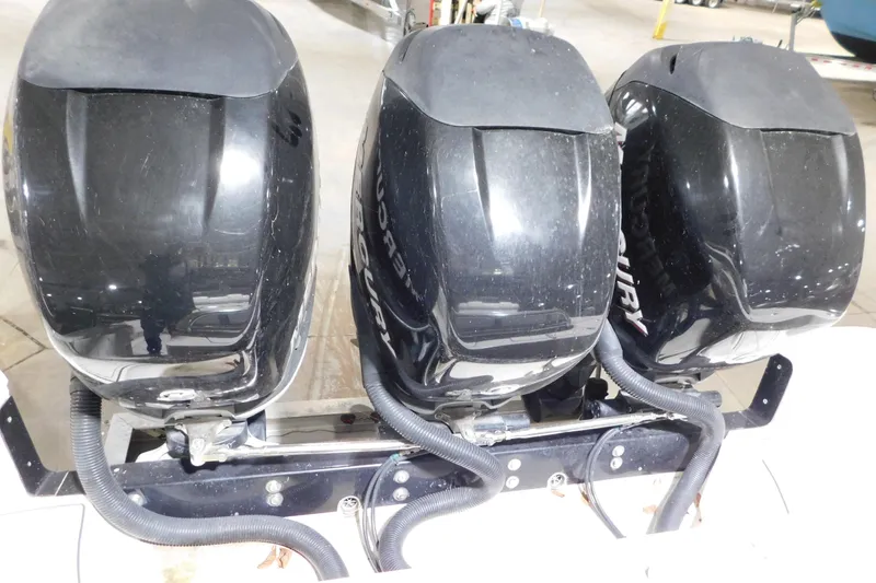 Slide: The Image of Triple Mercury outboard engines on a 2005 Fountain 34 Center Console boat. - 33