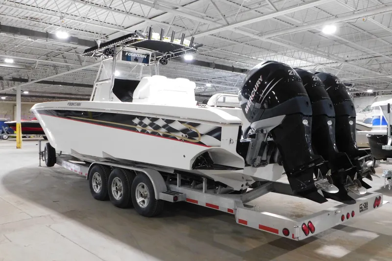 Slide: The Image of 2005 Fountain 34 Center Console boat with triple Mercury engines on a trailer. - 6