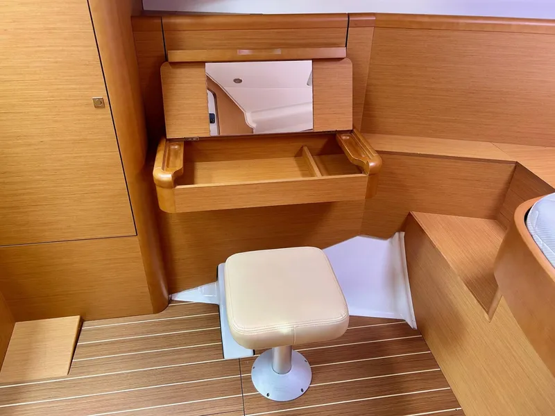 Slide: The Image of Interior of 2012 Jeanneau 50 DS yacht with wooden finish and cushioned stool. - 26