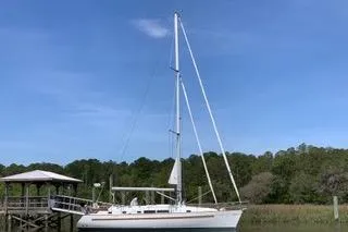 The Image of 1997 Beneteau Oceanis 40 CC sailboat docked in a marina. - 0