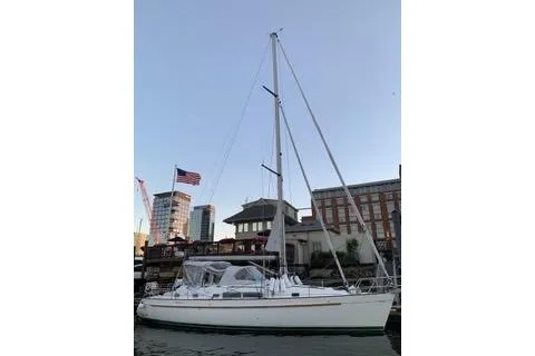 Slide: The Image of Sailboat Beneteau Oceanis 40 CC 1997 docked by a wooden pier, surrounded by lush greenery. - 1