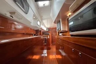 Slide: The Image of Sailing on a 1997 Beneteau Oceanis 40 CC yacht, navigating calm waters under a clear sky. - 12