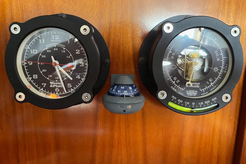 Slide: The Image of Analog clock and barometer on 1997 Beneteau Oceanis 40 CC yacht's wooden panel. - 23
