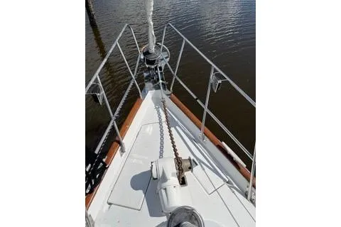 Slide: The Image of 1997 Beneteau Oceanis 40 CC with dinghy and US flag at dock. - 3