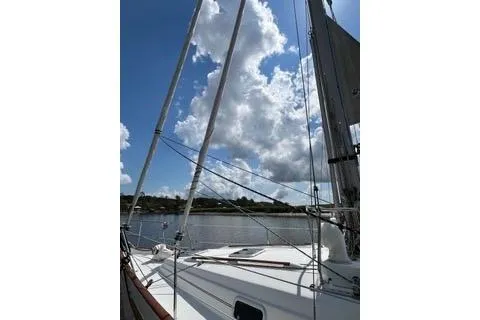 Slide: The Image of Sailboat deck view of 1997 Beneteau Oceanis 40 CC under a cloudy sky. - 5