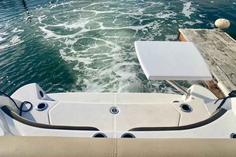 Slide: The Image of 2024 Yamaha Boats 222 FSH Sport E swim platform with water view. - 15