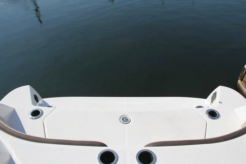 Slide: The Image of 2024 Yamaha Boats 222 FSH Sport E swim platform with cup holders, dockside view. - 4