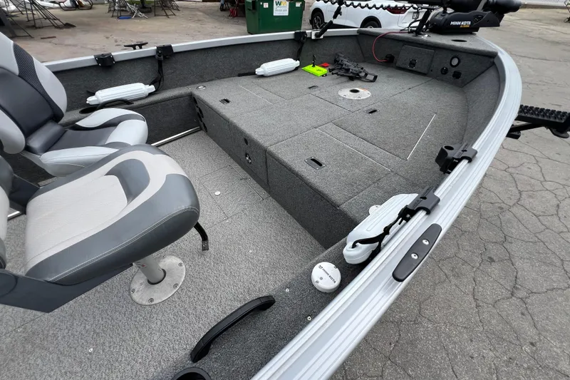 Slide: The Image of 2014 Alumacraft Competitor 165 Tiller boat interior with seating and storage compartments. - 11