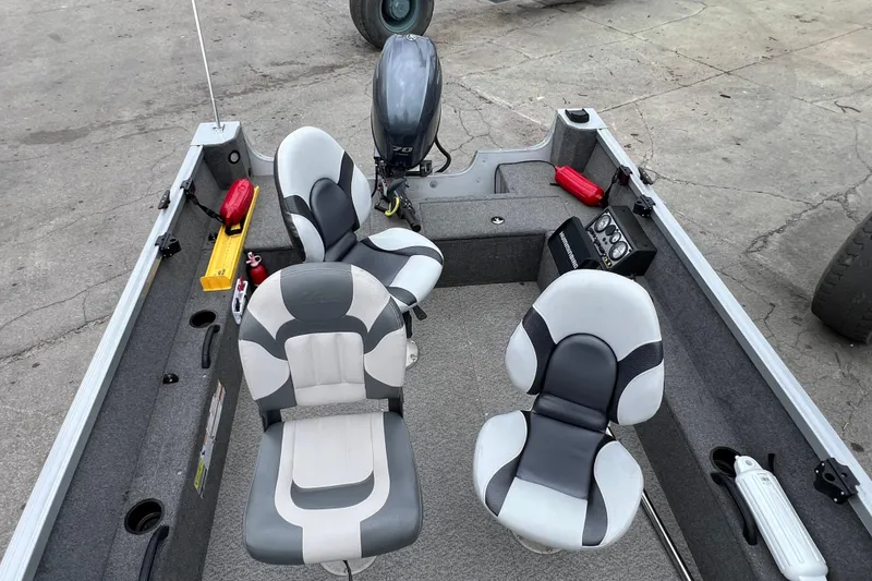 Slide: The Image of 2014 Alumacraft Competitor 165 Tiller boat interior with seats and motor. - 12