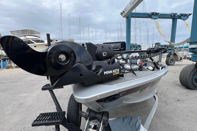 Slide: The Image of 2014 Alumacraft Competitor 165 Tiller with Minn Kota Ulterra motor at marina. - 14