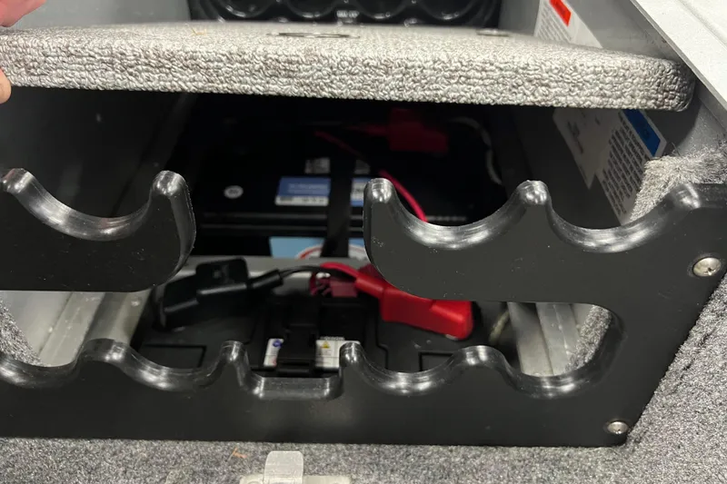 Slide: The Image of 2014 Alumacraft Competitor 165 Tiller battery compartment with secure storage slots. - 20