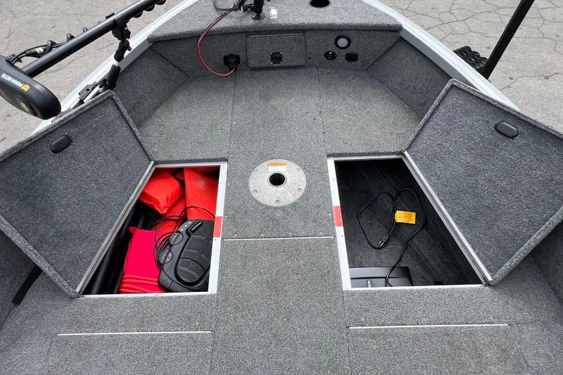Slide: The Image of 2014 Alumacraft Competitor 165 Tiller boat interior with open storage compartments. - 21