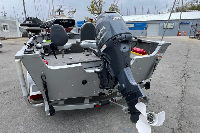 Slide: The Image of 2014 Alumacraft Competitor 165 Tiller boat with Yamaha 70 outboard motor at marina. - 6