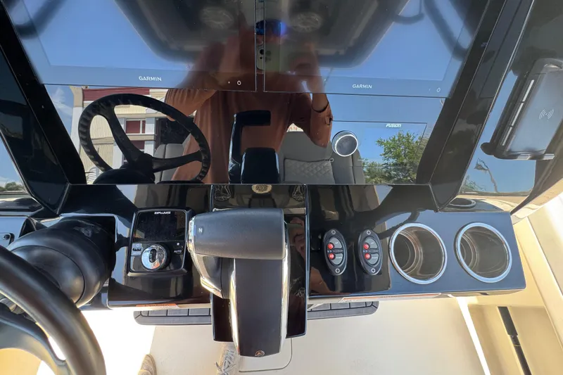 Slide: The Image of 2024 Scout 281 XSS boat dashboard with Garmin displays and controls. - 15