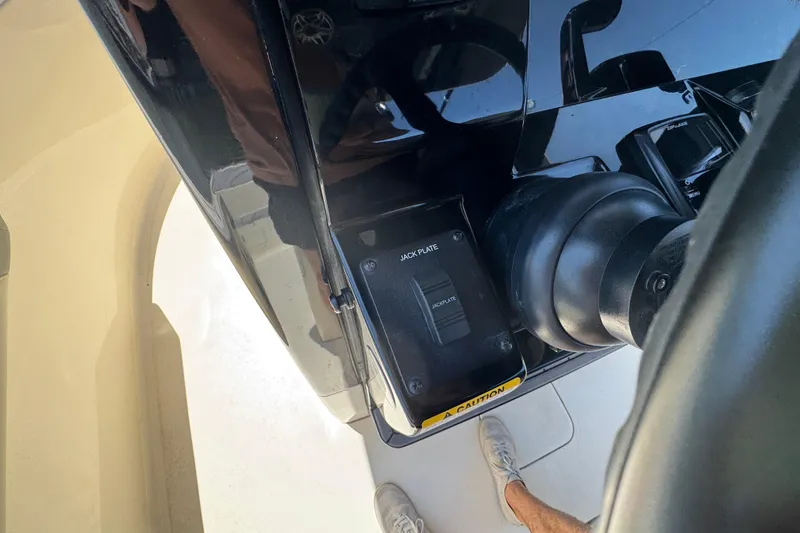 Slide: The Image of Close-up of 2024 Scout 281 XSS boat's jack plate control and motor. - 16