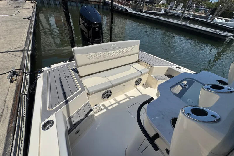 Slide: The Image of 2024 Scout 281 XSS boat interior with seating and engine at dock. - 20