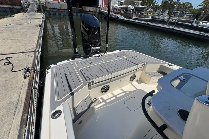 Slide: The Image of 2024 Scout 281 XSS boat docked, showcasing spacious deck and powerful Mercury engine. - 21