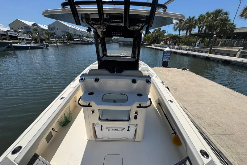 Slide: The Image of 2024 Scout 281 XSS boat docked at a marina with clear skies. - 22