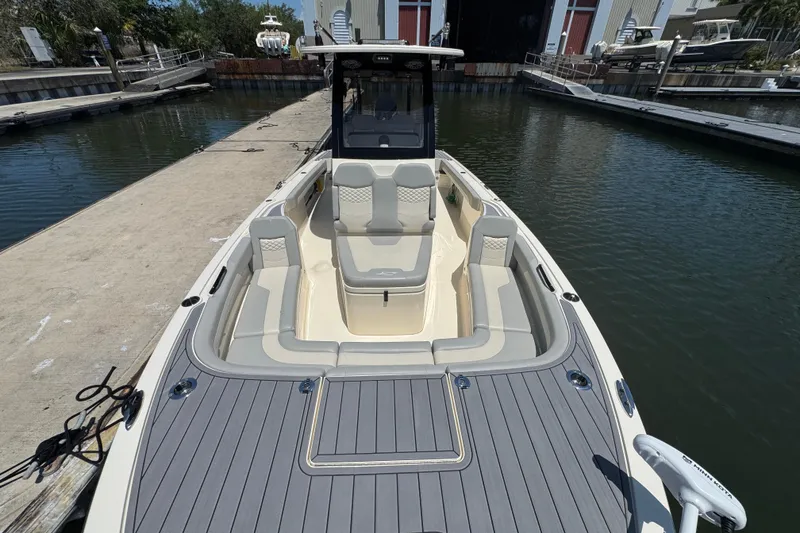 Slide: The Image of 2024 Scout 281 XSS boat docked, featuring spacious seating and sleek design. - 8