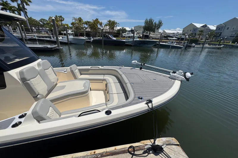 Slide: The Image of 2024 Scout 281 XSS boat docked in a marina, featuring luxurious seating and sleek design. - 9