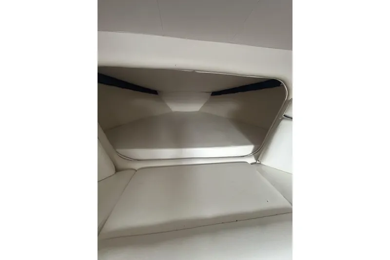 Slide: The Image of Interior cabin of 2006 Donzi 43 ZR boat, featuring sleek white seating. - 13
