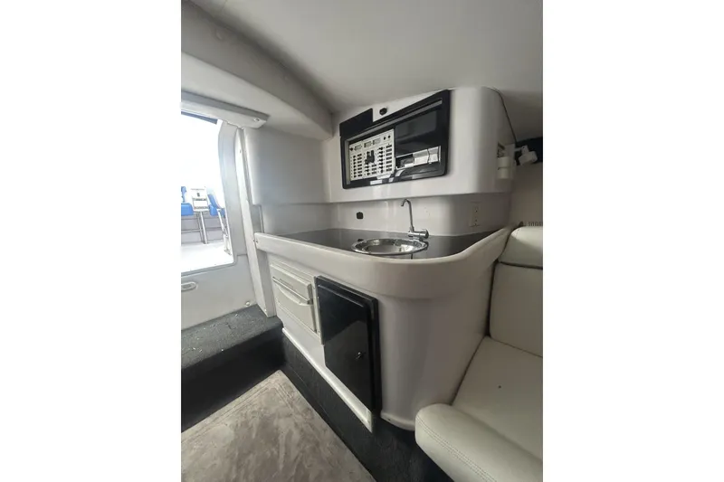 Slide: The Image of Interior of a 2006 Donzi 43 ZR boat featuring a compact kitchenette. - 14