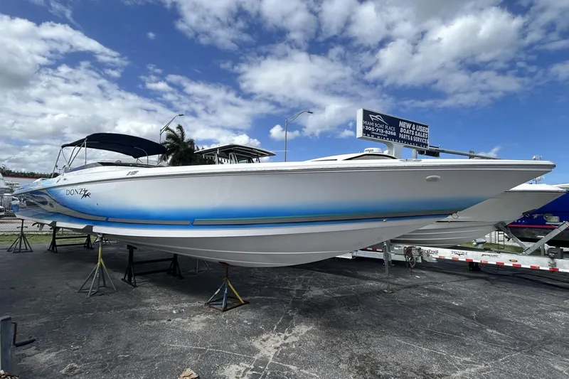 Slide: The Image of 2006 Donzi 43 ZR speedboat displayed outdoors under a partly cloudy sky. - 17