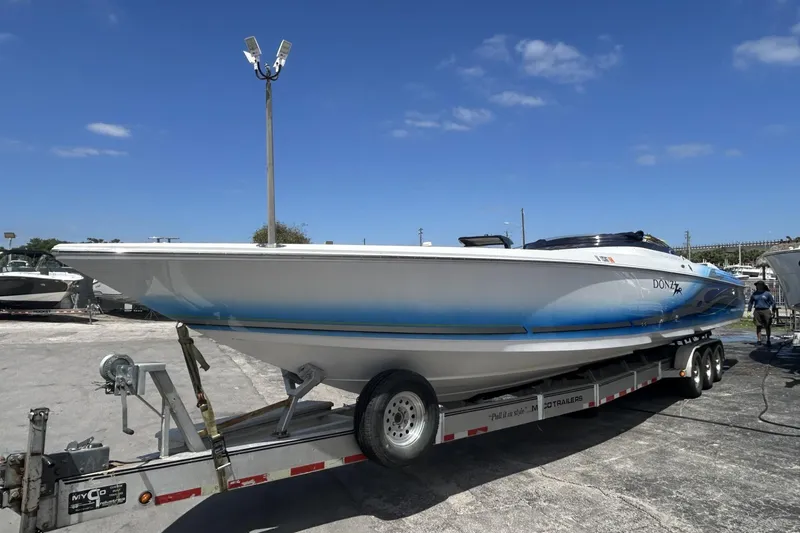Slide: The Image of 2006 Donzi 43 ZR speedboat on trailer under clear blue sky. - 22