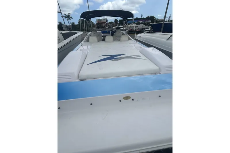 Slide: The Image of 2006 Donzi 43 ZR speedboat with sleek design, docked under a blue sky. - 26