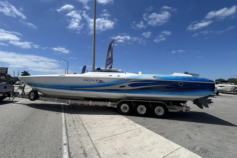 Slide: The Image of 2006 Donzi 43 ZR speedboat on trailer under clear blue sky. - 27