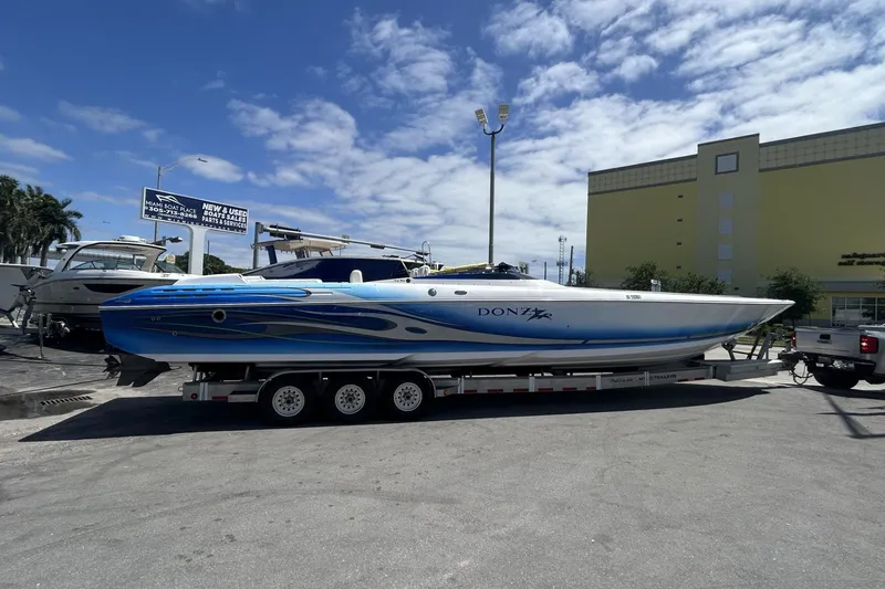 Slide: The Image of 2006 Donzi 43 ZR speedboat on trailer under clear blue sky. - 28