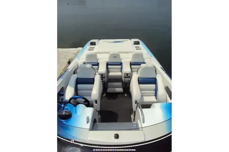 Slide: The Image of 2006 Donzi 43 ZR boat interior with white and blue seating, docked on calm water. - 3