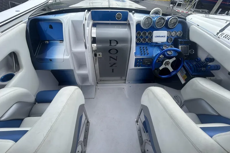 Slide: The Image of 2006 Donzi 43 ZR boat cockpit with blue and white interior, steering wheel, and control panel. - 5