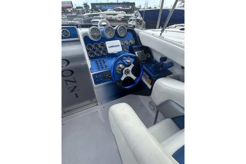 Slide: The Image of 2006 Donzi 43 ZR boat cockpit with blue steering wheel and instrument panel. - 6
