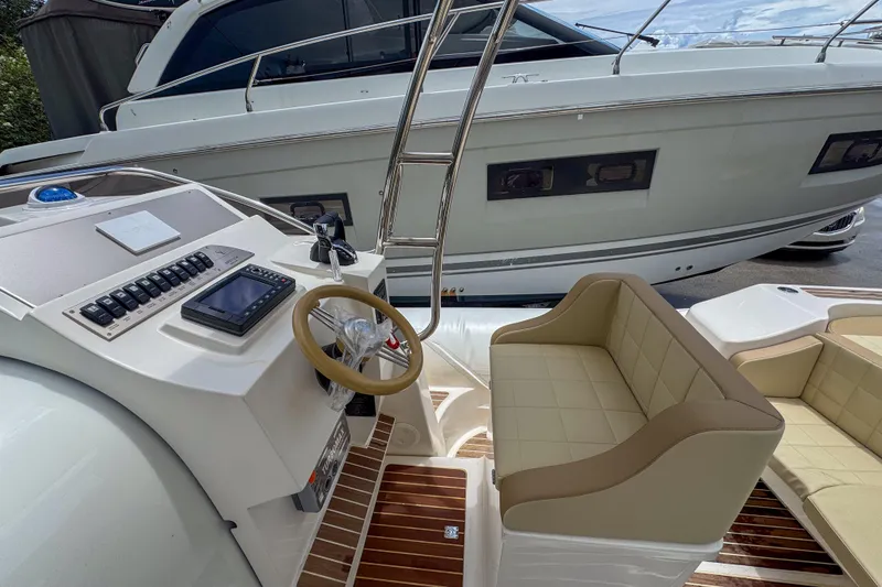 Slide: The Image of 2023 Tender Impertus 36 boat interior with steering console and seating area. - 10