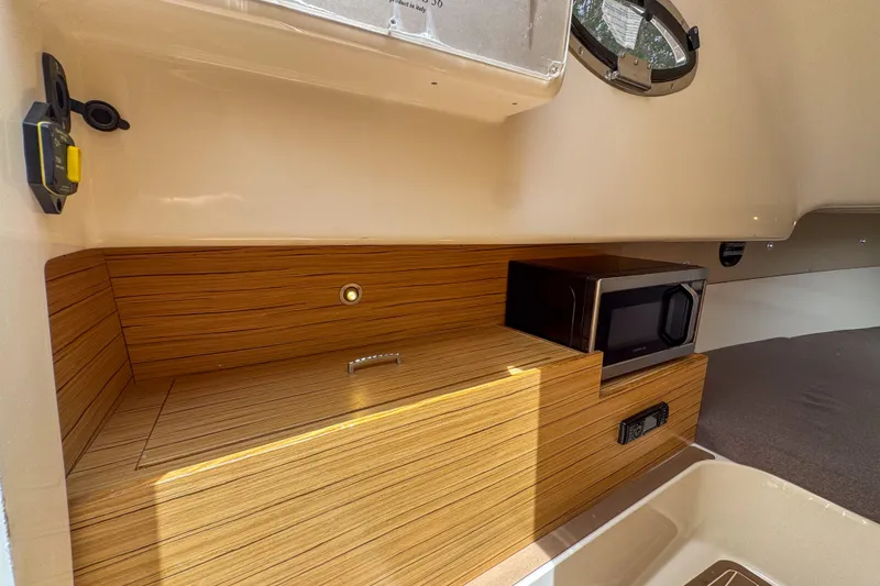 Slide: The Image of 2023 Tender Impertus 36 interior with wood finish and built-in microwave. - 25