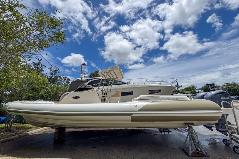 Slide: The Image of 2023 Tender Impertus 36 boat on display under a partly cloudy sky. - 3