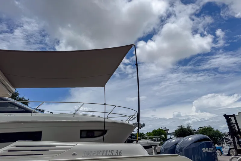 Slide: The Image of 2023 Tender Impertus 36 boat with canopy under a partly cloudy sky. - 45