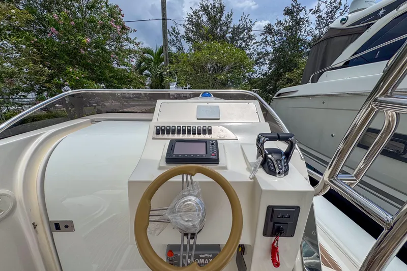 Slide: The Image of 2023 Tender Impertus 36 boat dashboard with steering wheel and control panel. - 9