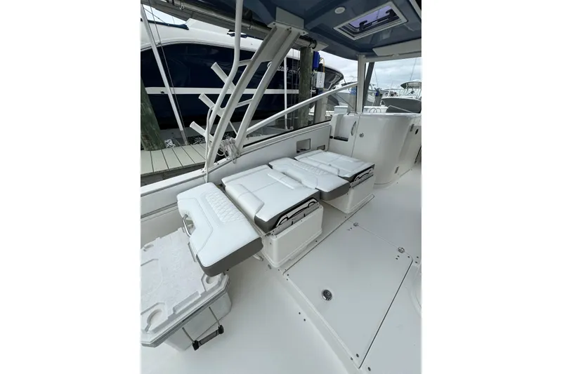Slide: The Image of 2022 World Cat 325 DC boat interior with white seating and modern design. - 10