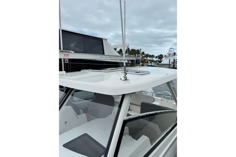 Slide: The Image of 2022 World Cat 325 DC boat docked, showcasing sleek design and modern features. - 16