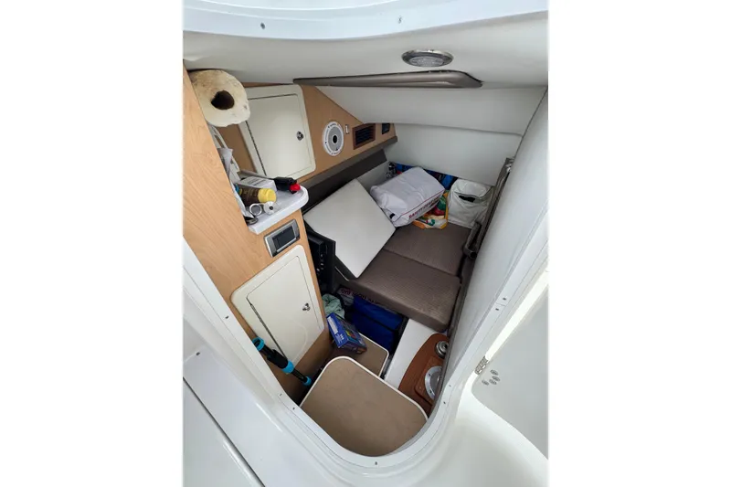 Slide: The Image of Interior cabin of 2022 World Cat 325 DC boat, featuring storage and seating. - 19