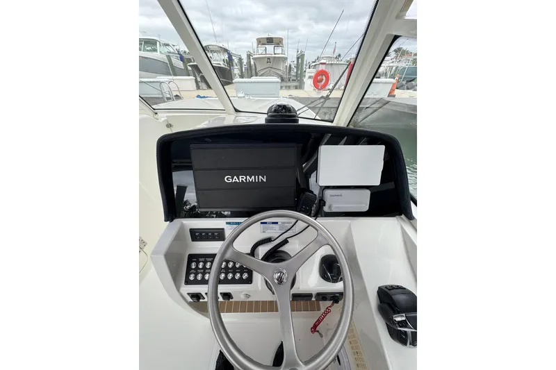 Slide: The Image of Cockpit view of 2022 World Cat 325 DC with Garmin navigation system. - 21