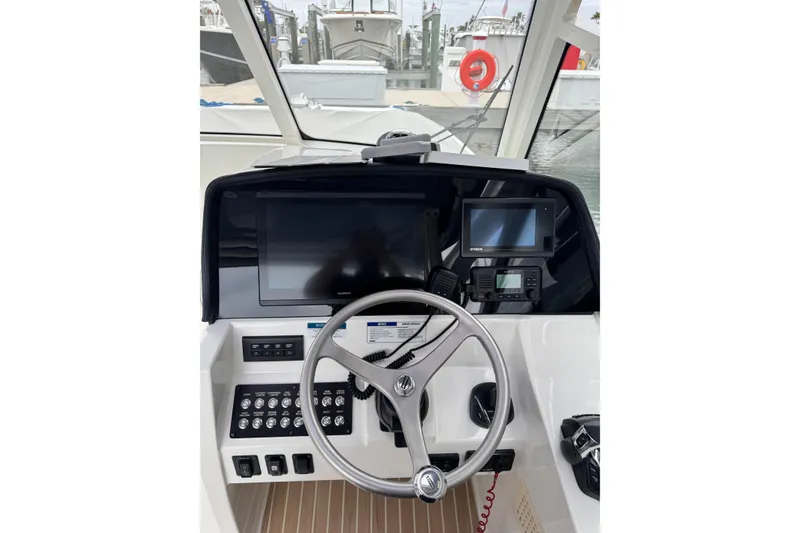 Slide: The Image of Helm of 2022 World Cat 325 DC boat with modern navigation equipment and steering wheel. - 23