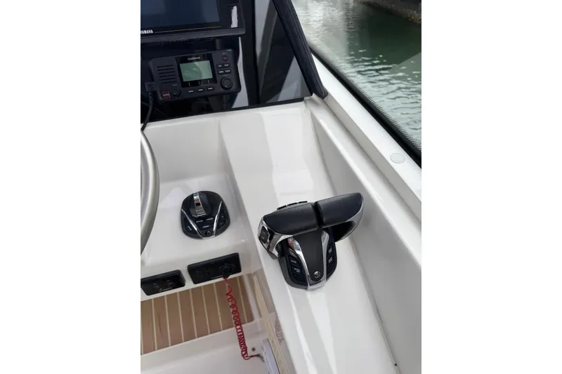 Slide: The Image of Control panel of 2022 World Cat 325 DC boat with throttle and navigation equipment. - 24